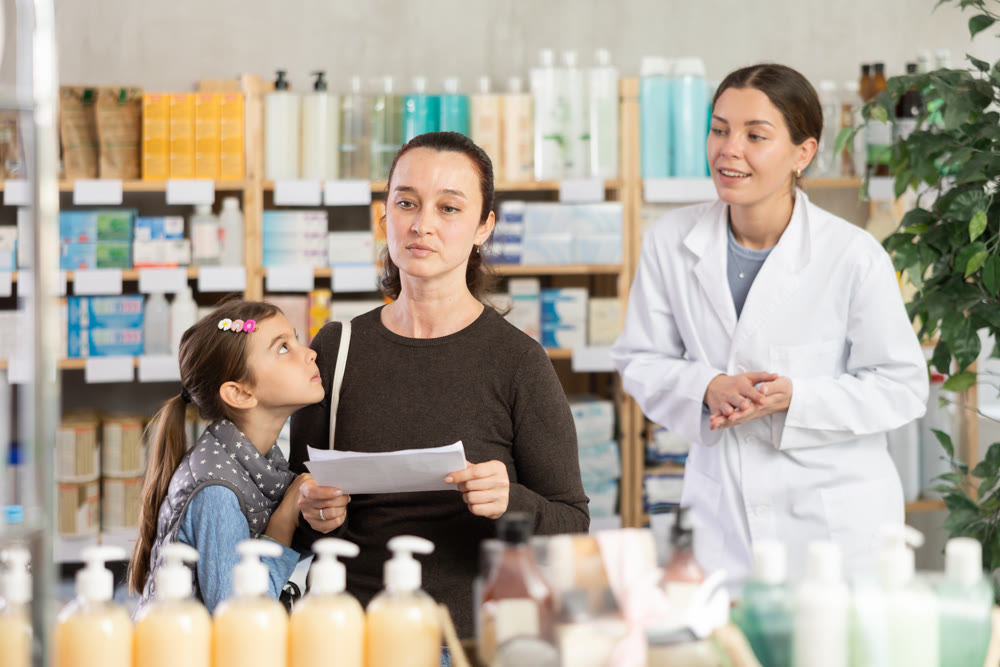 Woman with prescription looking for items in pharmacy