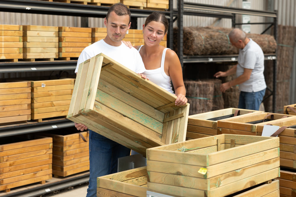 Couple customers chooses wooden box in store.