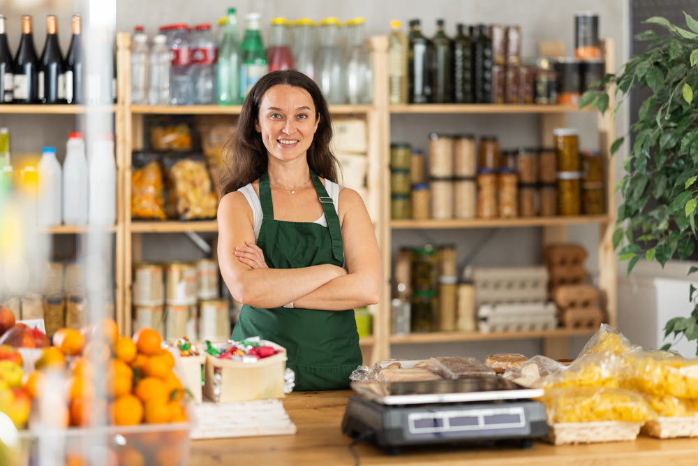 Woman seller at counter in grocery store