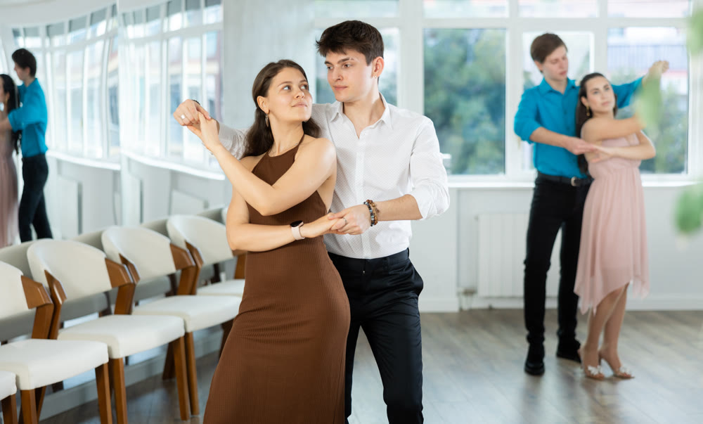 Couple young woman and man dancing waltz