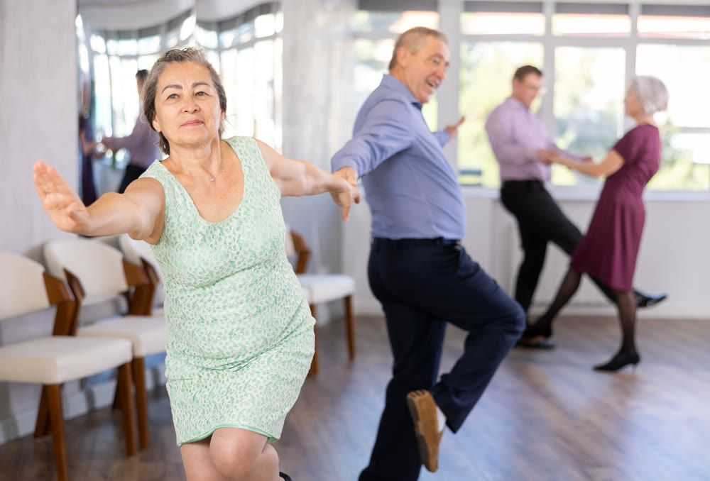 Elderly man and elderly woman dance twist