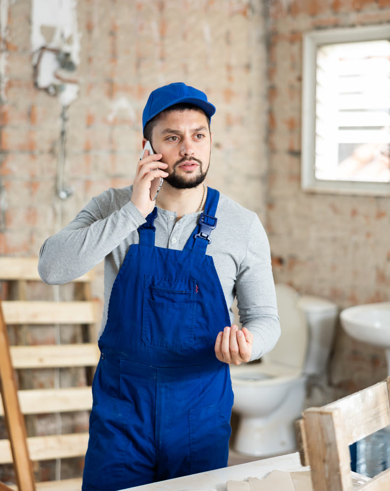 Builder is talking on a mobile phone