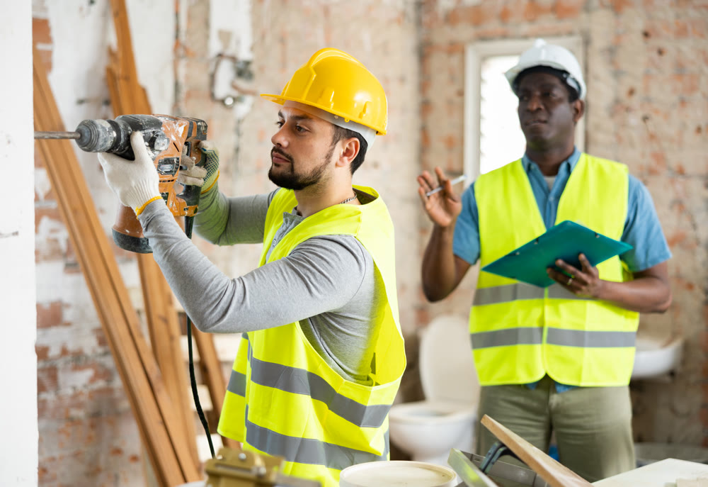 Confident builder posing on indoor construction site