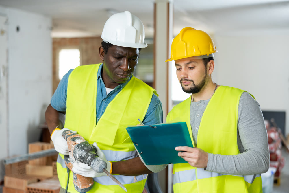 Architects discussing project documentation in construction site