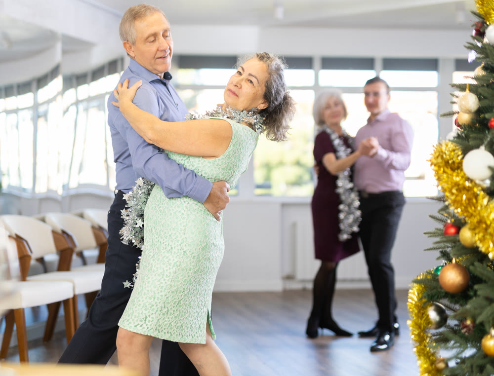 Cheerful adults celebration Christmas and dancing samba latin dance with partners in dancing class