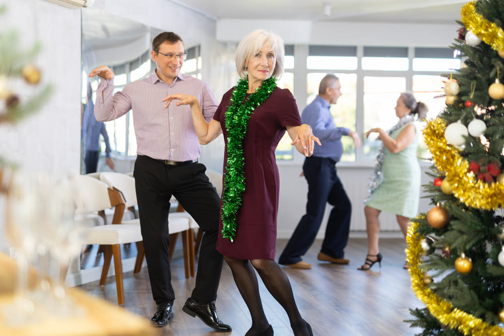 Adult man and elderly woman dance twist