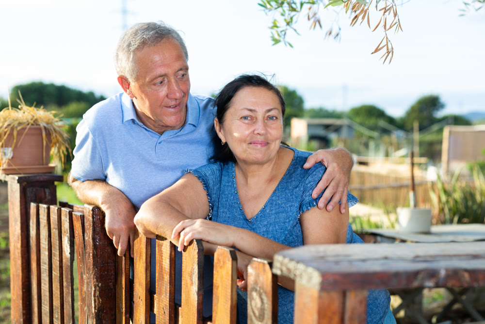 Cute senior couple in backyard garden