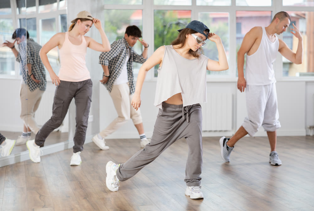 Young girl practicing hip hop slide moves in training hall
