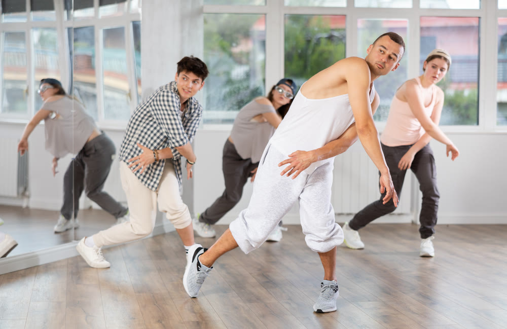Hip-hop dance performed by group of young dancers in dance studio
