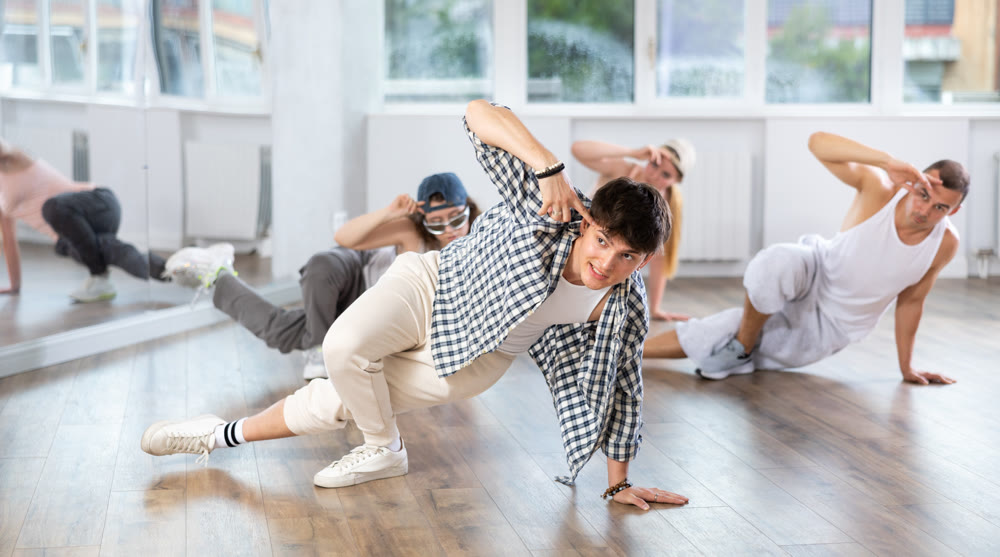 Group of dancers having break dance training at dance studio
