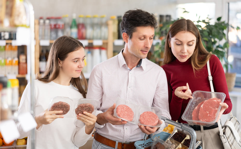 Couple of man and woman with girl choosing hamburger or entrecote