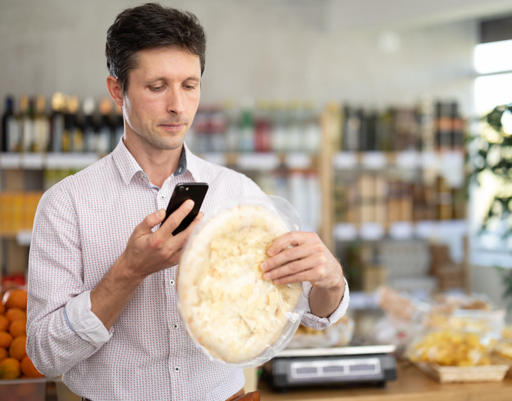Man scans a pizza on his phone