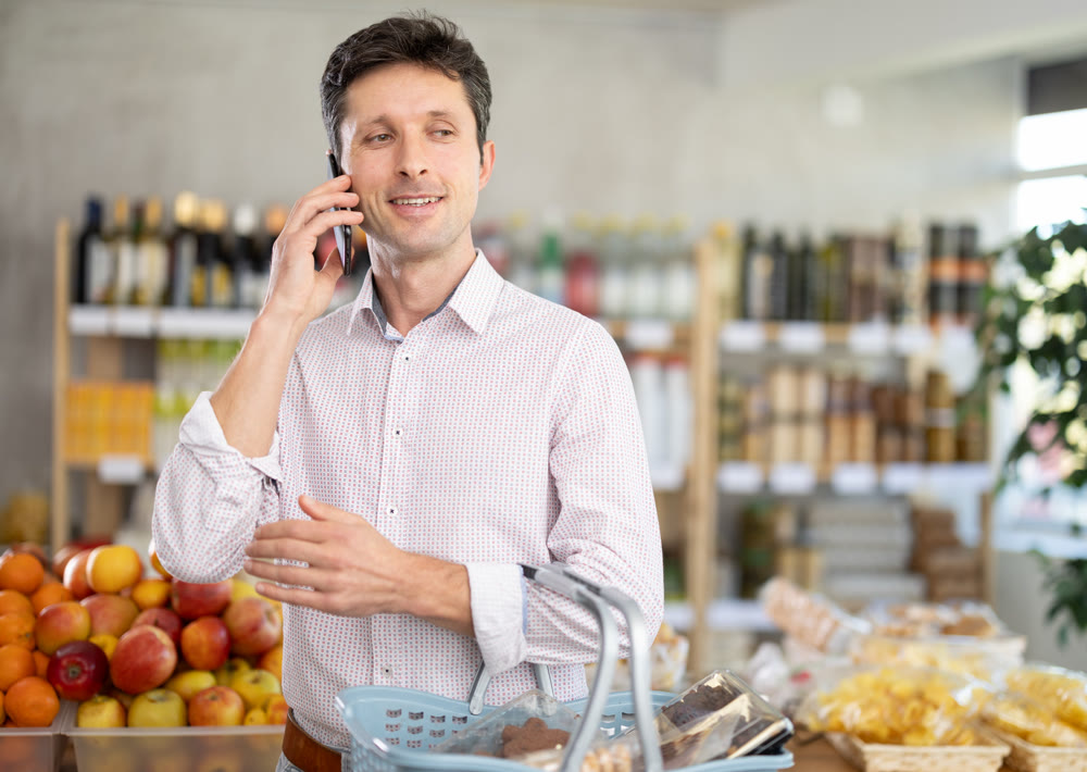 man calls on the mobile phone of the store