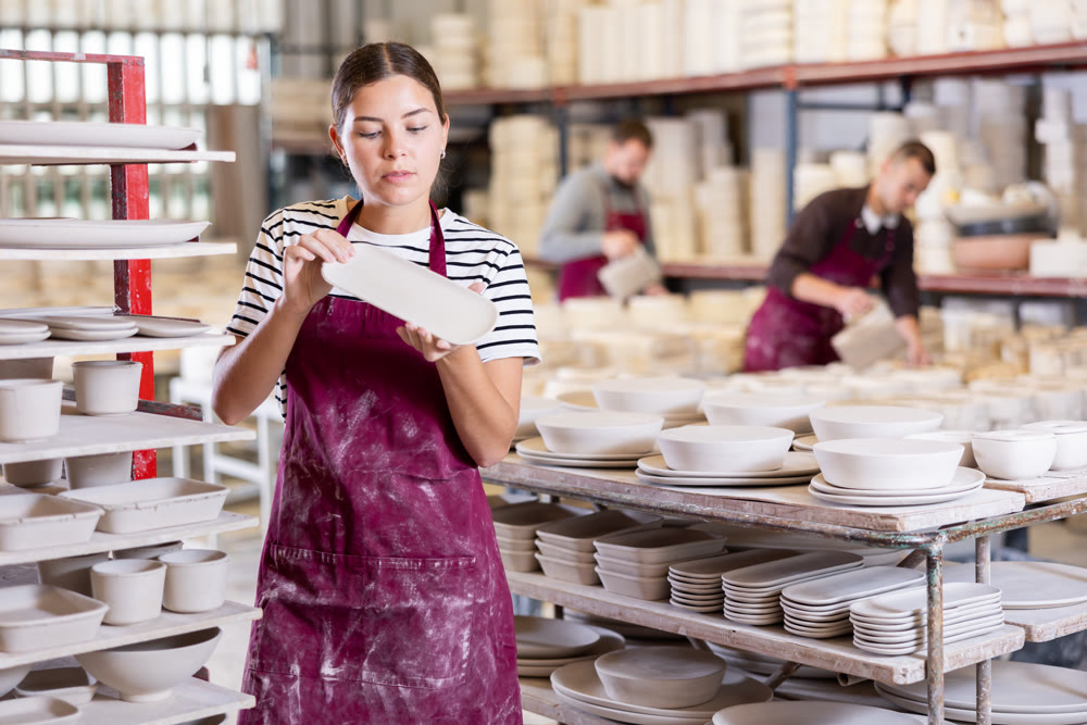 Young woman posing with ceramic blanks