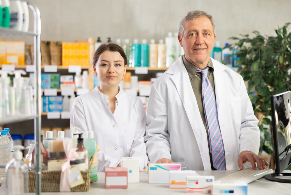 Man and woman pharmacists invite you to pharmacy