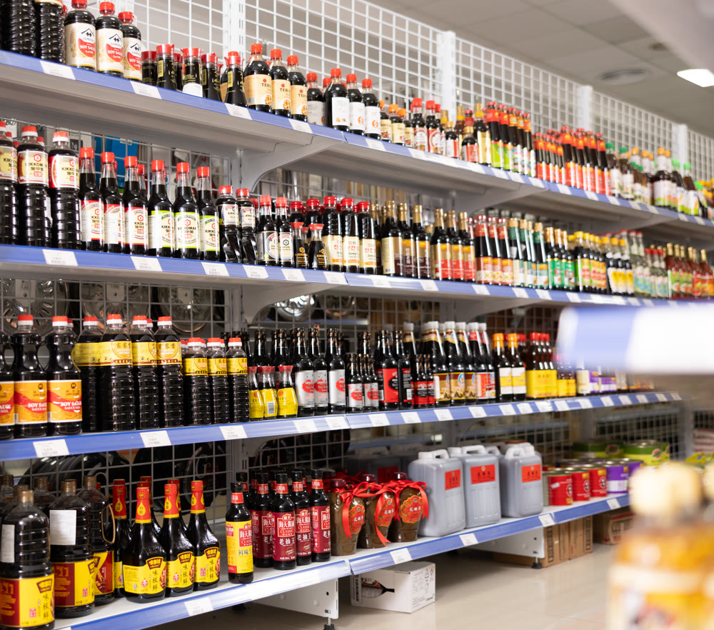 Reus, Spain - May 30, 2024: Bottles with various soy sauces on the shelves in Chinese supermarket