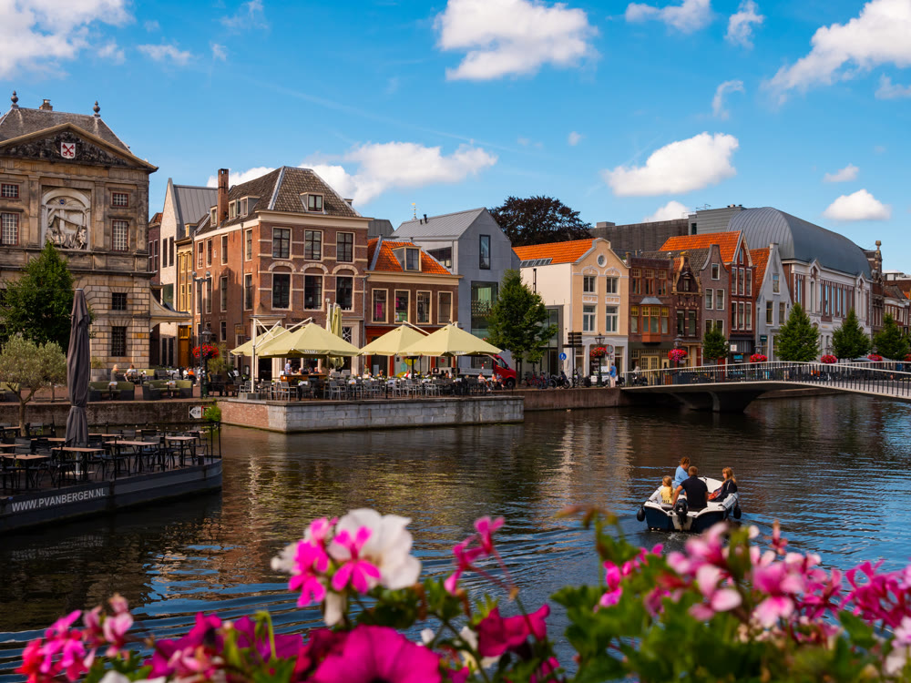 Leiden, Netherlands - August 08, 2022: Traditional houses beside a canal in Leiden - South Holland, Netherlands