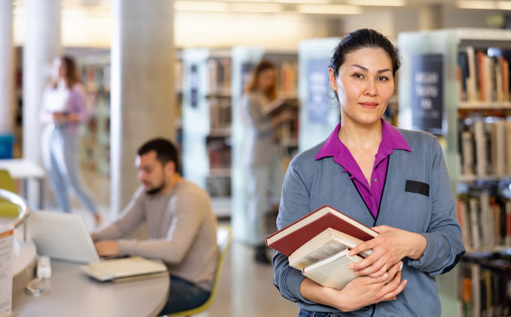Portrait of an asian woman in a library with books