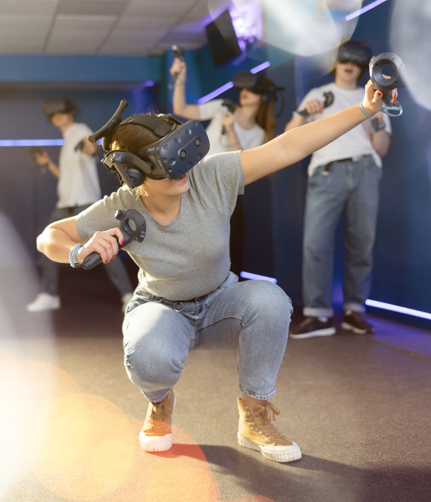 girl in virtual helmet squatted down and actively participates in university eSports competition