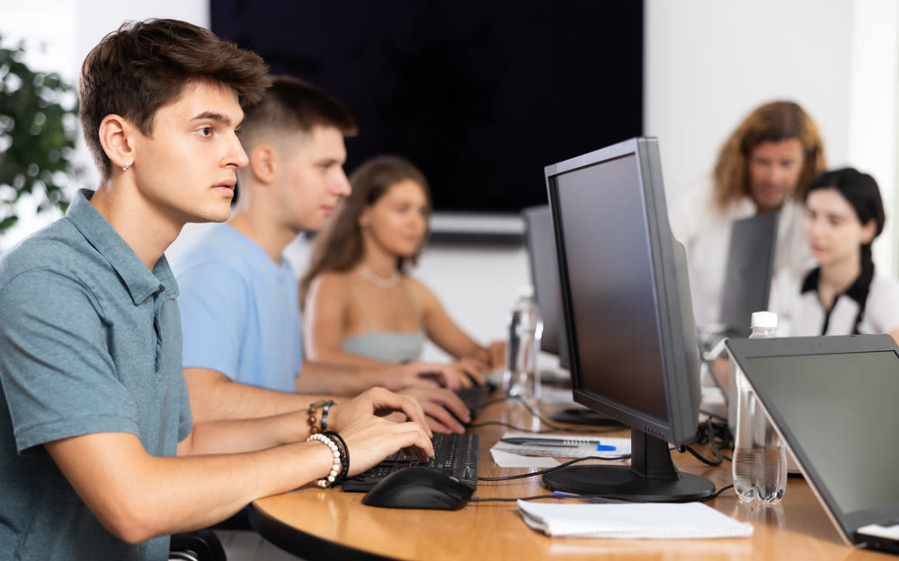 student sits near computer