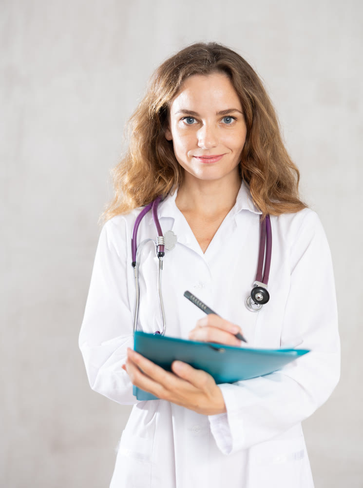 Young female doctor taking notes in studio