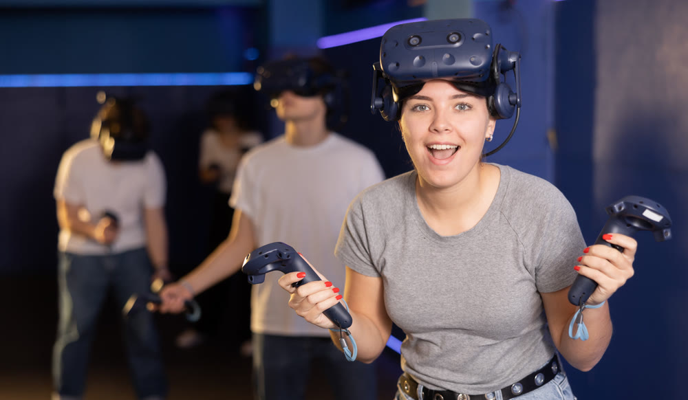 girl is exhilarated by turn of events in VR game and moved virtual reality glasses to forehead