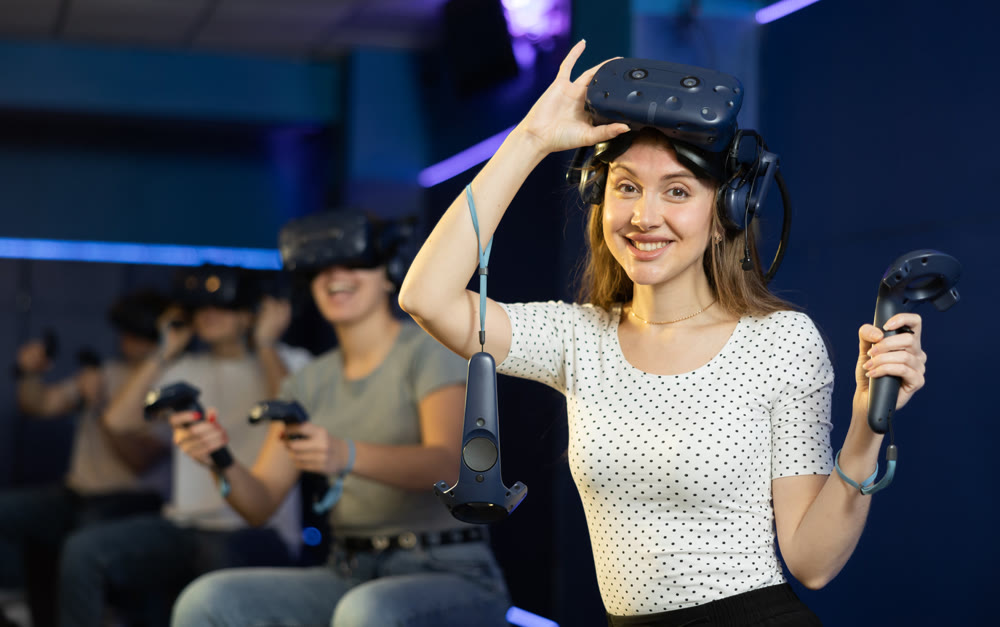 Surprised girl wearing VR headset playing virtual reality games in room