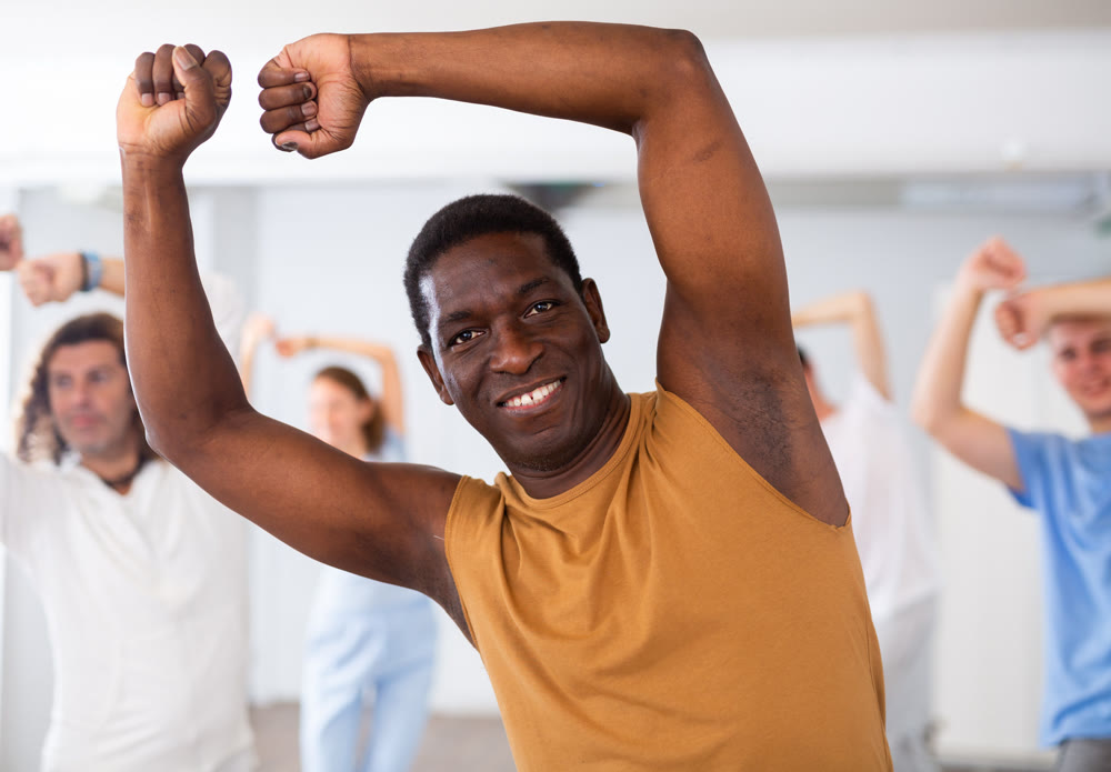African american man with friends training hip hop in dance studio