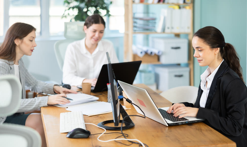 Female young colleagues working in modern office