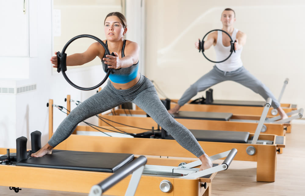 Girl restores her health with the help of gymnastic ring during Pilates classes