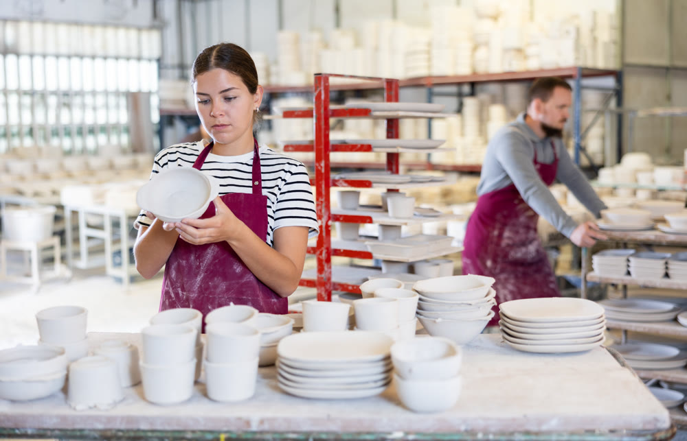 Young woman posing with ceramic blanks