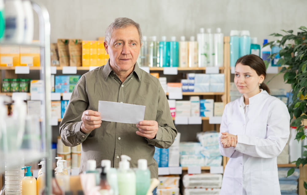Man choosing prescription medications with help of pharmacist