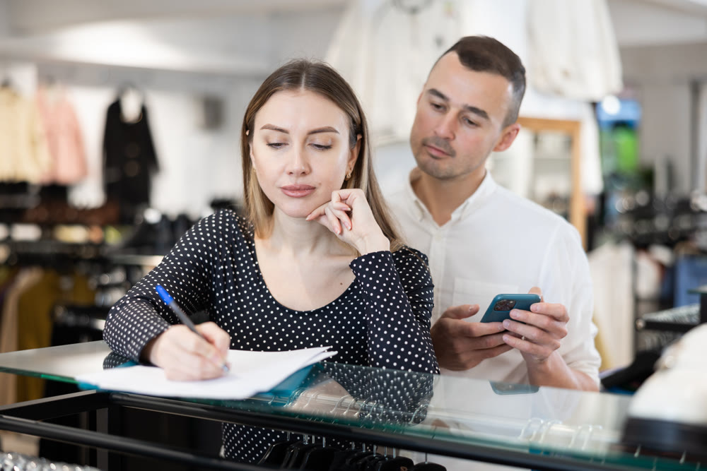 Couple woman and man with phone signing document