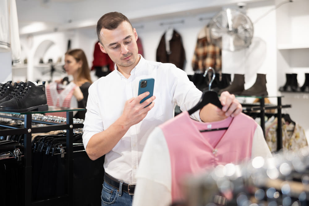 Young man makes video call and chooses blouse