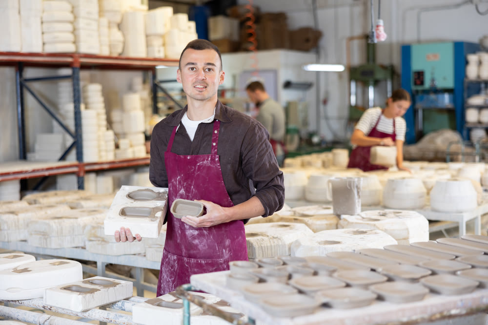 Ceramist explaining process of forming ceramic dishes in slipcasting molds