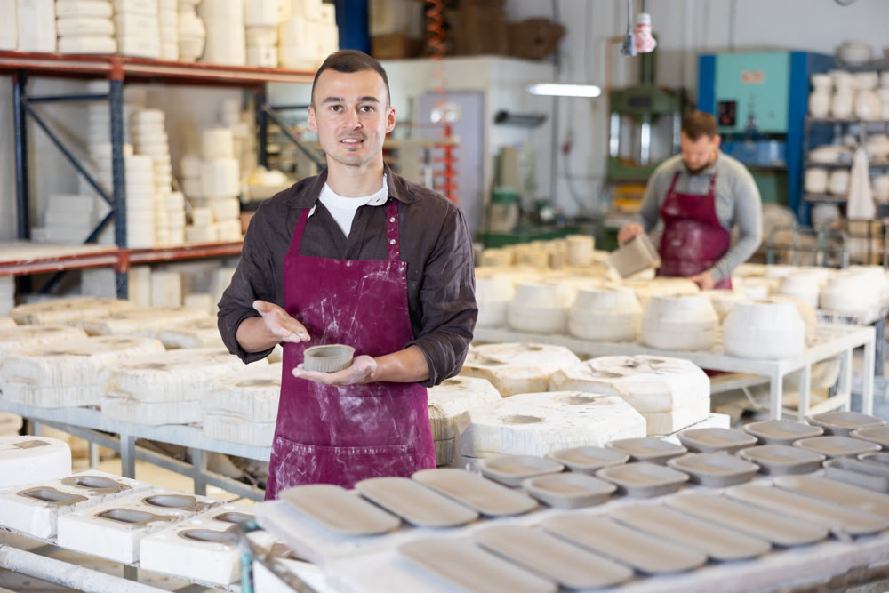 Young man posing with ceramic blanks