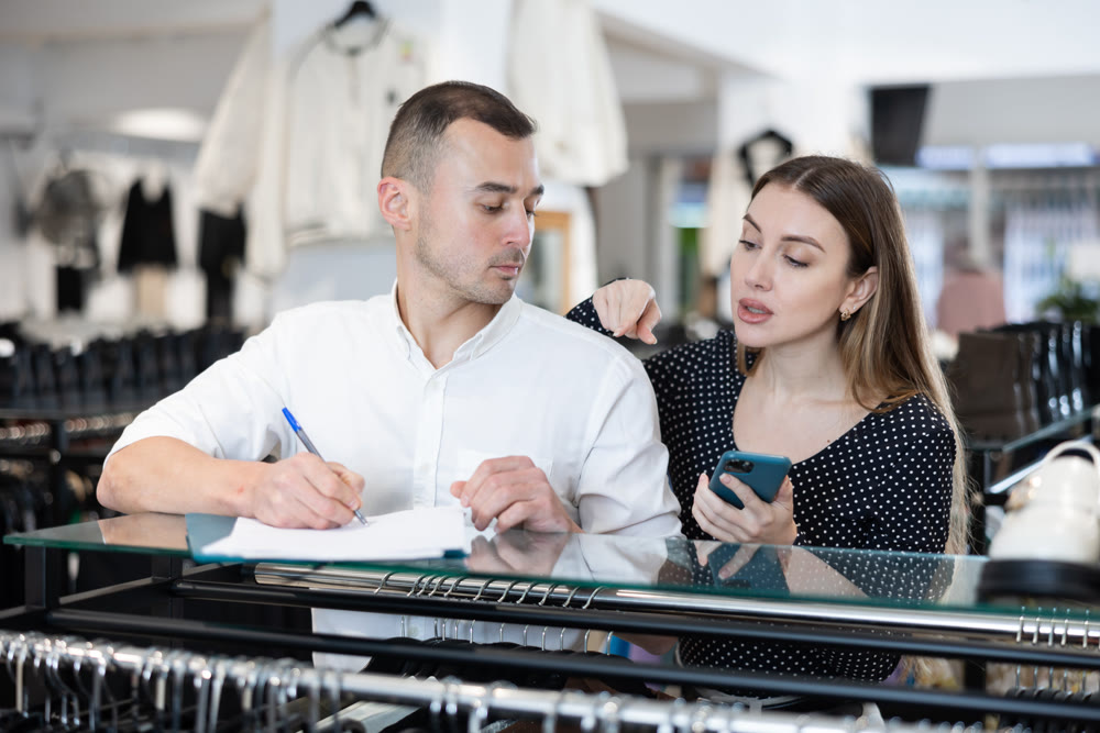 Couple man and woman with phone signing document