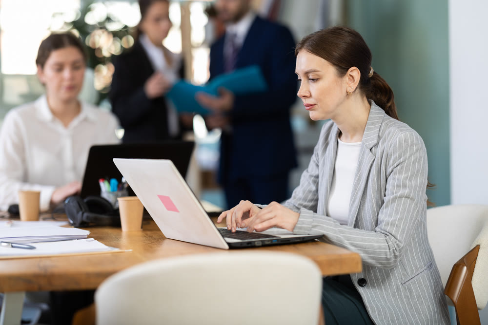 Young woman is a qualified specialist, works in a modern office