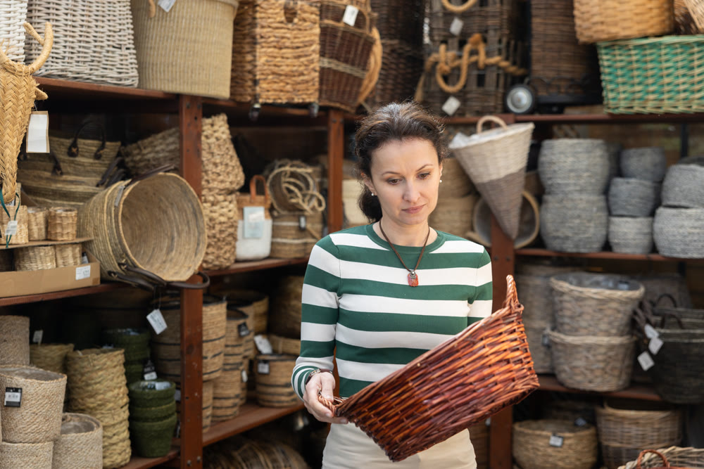 Adult woman choosing basket in store