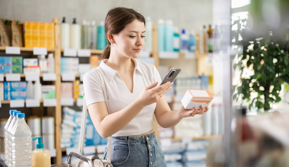 Girl scans code on package of pills to check the expiration date