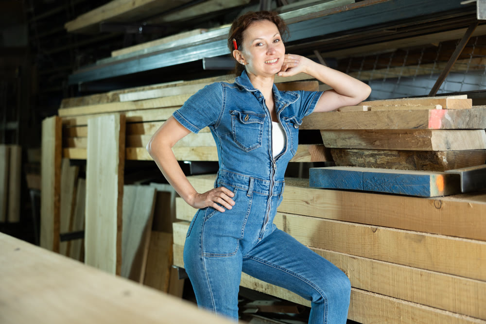 Portrait of positive female lumber warehouse worker