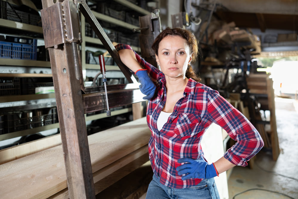 Preparing metal structures - woman secures metal profile with clamp
