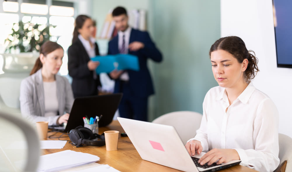 Young woman is a qualified specialist, works in a modern office