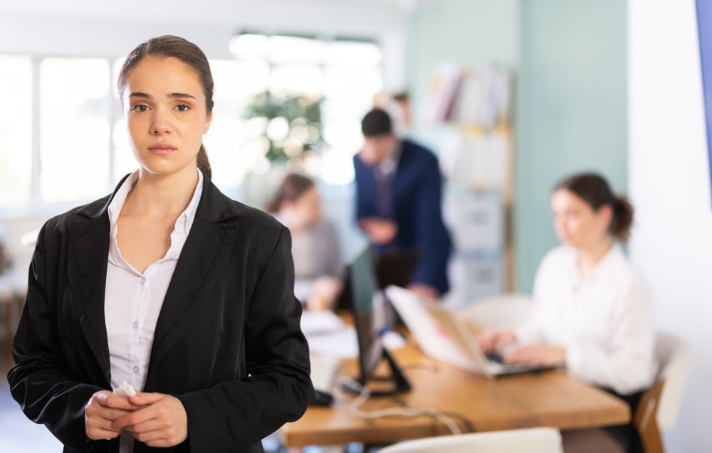 Sad young woman while working in office