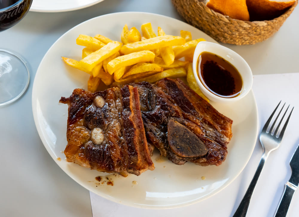 Grilled beef ribs with french fries and sauce