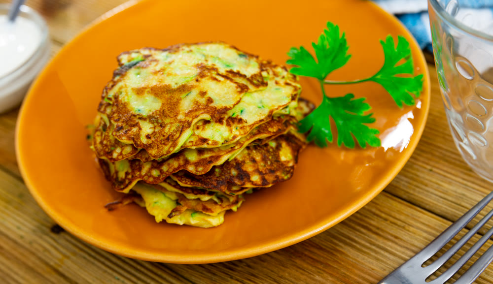 On plate are vegetable pancakes made from grated zucchini