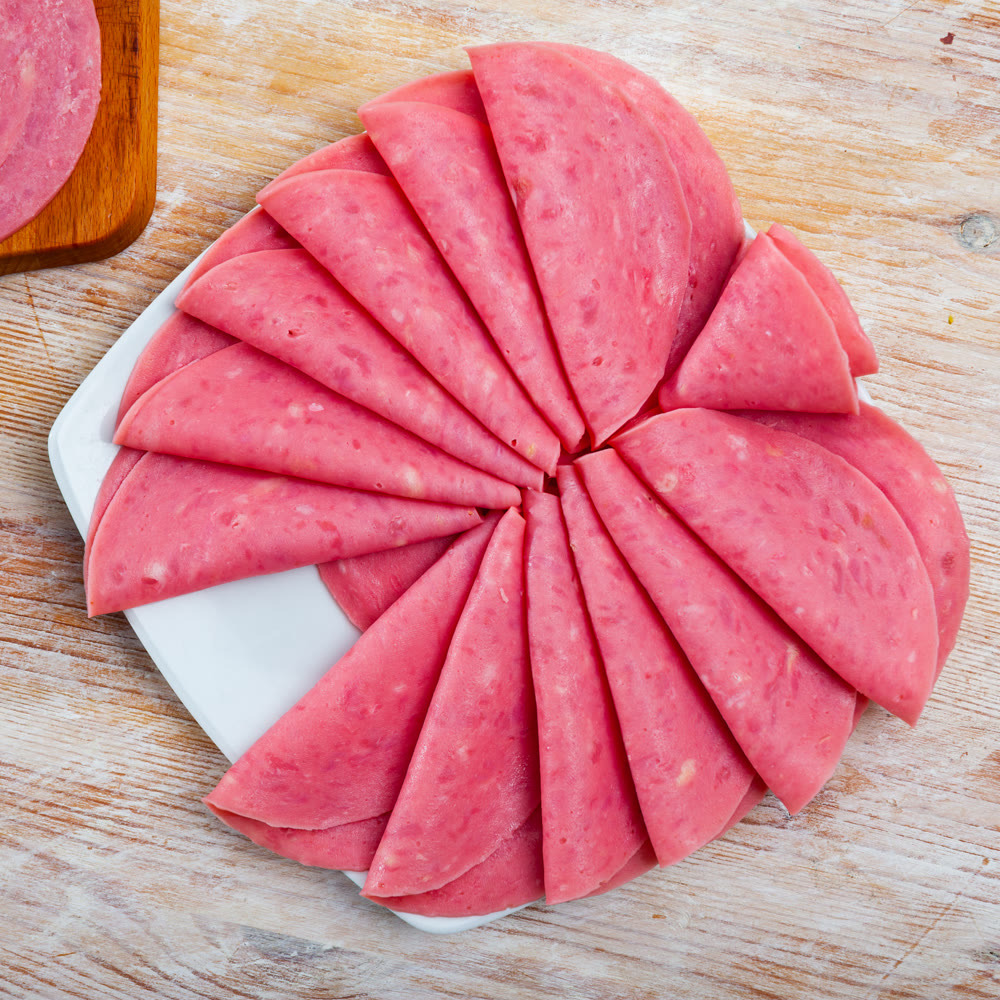Slices of sausage mortadella from turkey on board