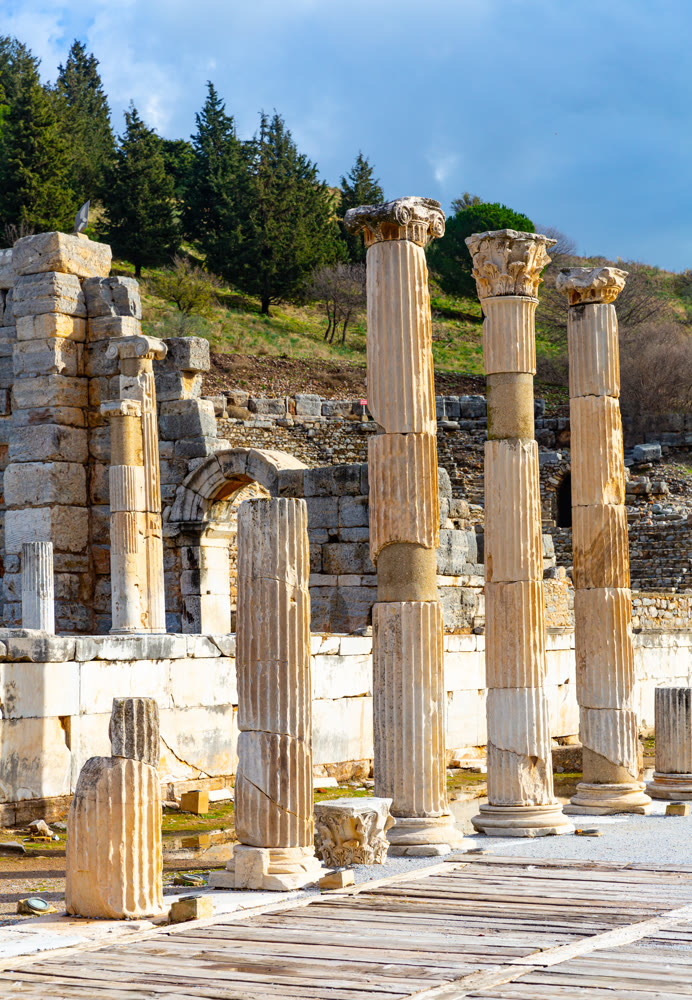 State Agora columns in ancient Ephesus with Odeon ruins in background