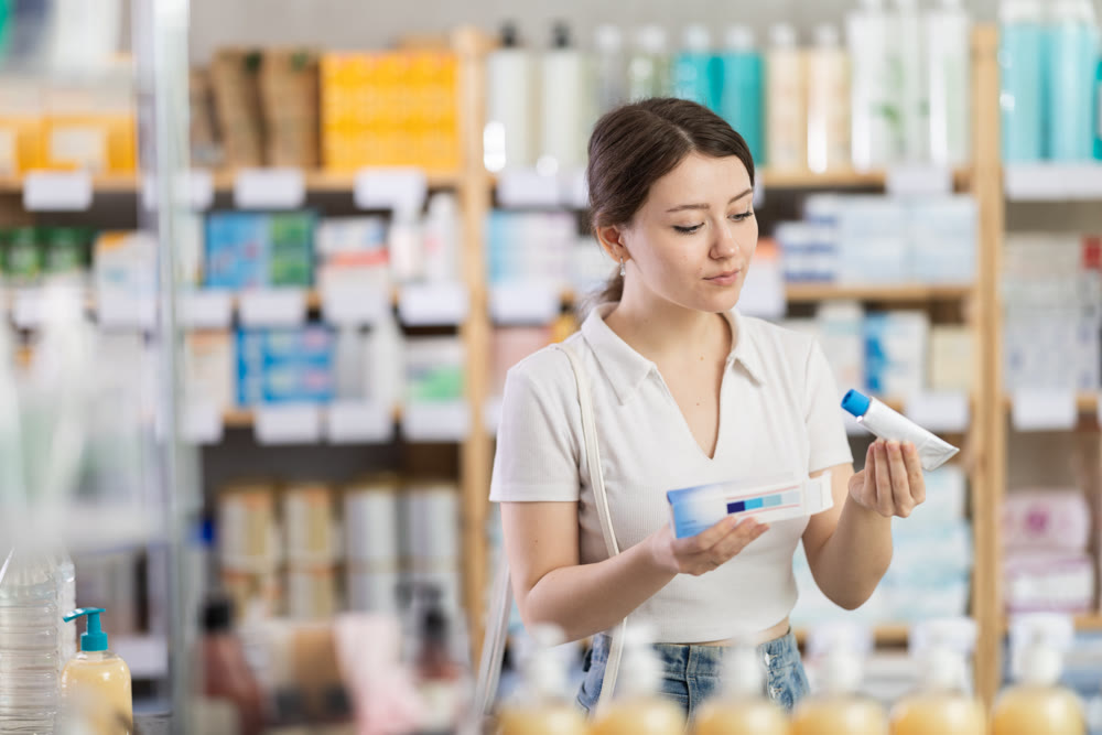 woman chooses a warming ointment for joints