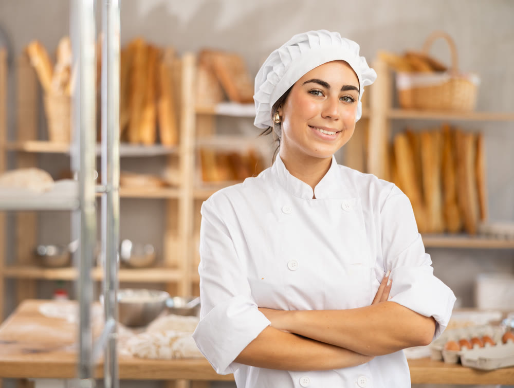 Young female baker posing in workshop